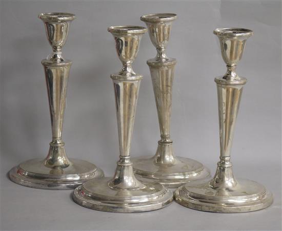 A set of four white metal oval candlesticks, (a.f.), weighted.